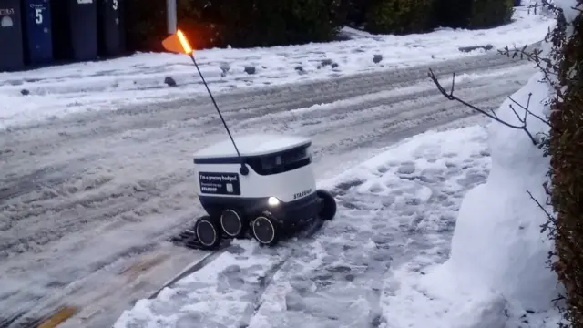 Delivery robot stuck on an icy kerb in Cambridge