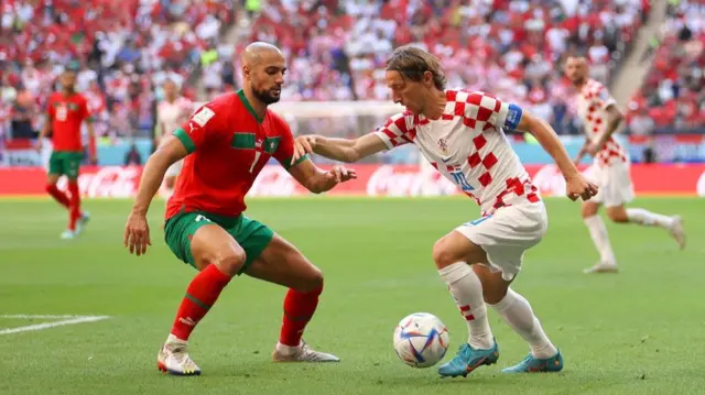 Luka Modric takes on Sofyan Amrabat