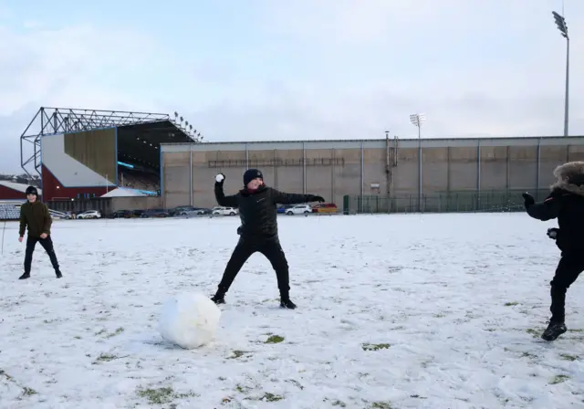 Fans playing in the snow outside Turf Moor