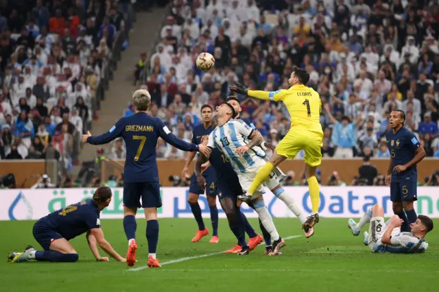 Hugo Lloris and Christian Romero challenge for the ball