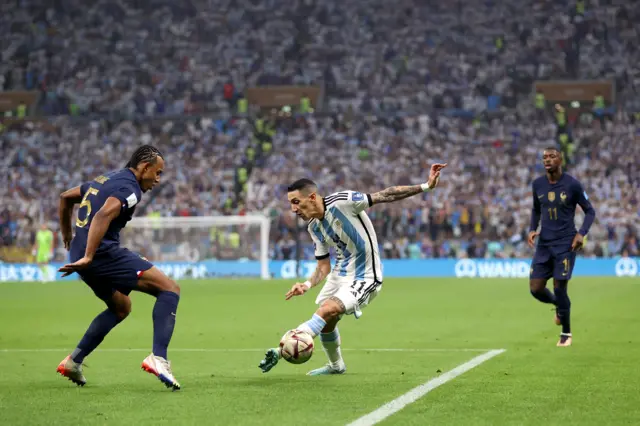 Angel di Maria runs at Jules Kounde during the World Cup final