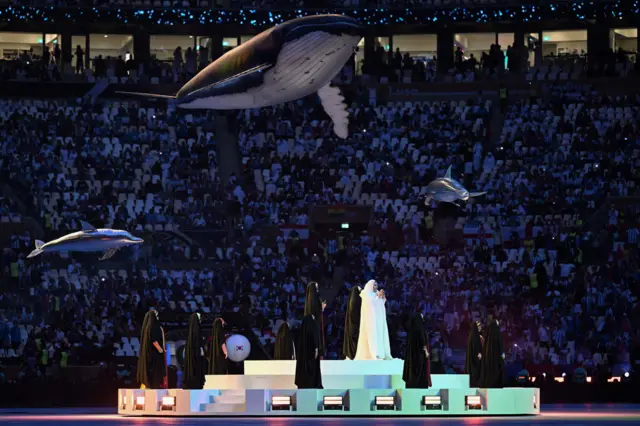 An artist performs during the closing ceremony ahead of the start of the Qatar 2022 World Cup final football match between Argentina and France at Lusail Stadium in Lusail, north of Doha