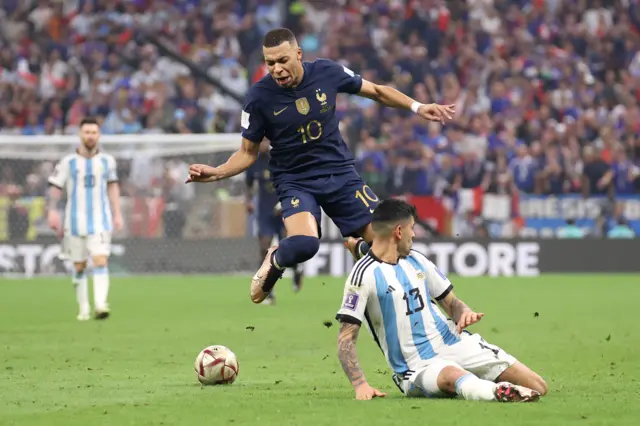 Christian Romero tackles Kylian Mbappe