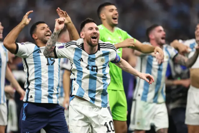 Lionel Messi celebrates winning the World Cup, with Sergio Aguero in the background