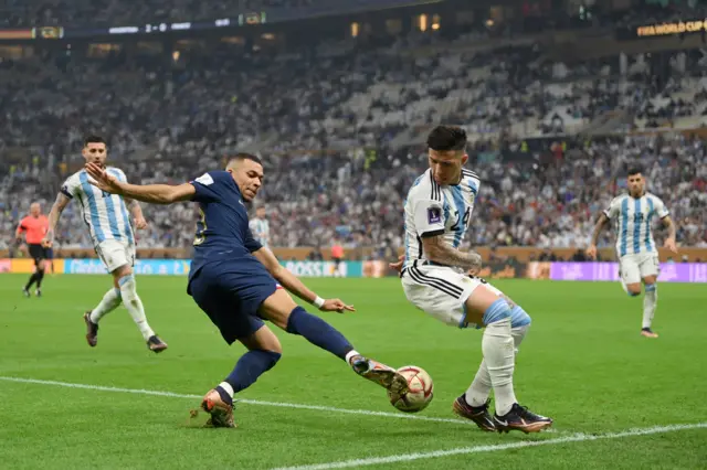 Kylian Mbappe of France battles for possession with Enzo Fernandez of Argentina during the FIFA World Cup Qatar 2022 Final match between Argentina and France at Lusail Stadium