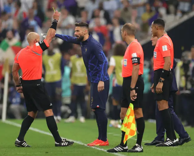 Olivier Giroud is shown a yellow card