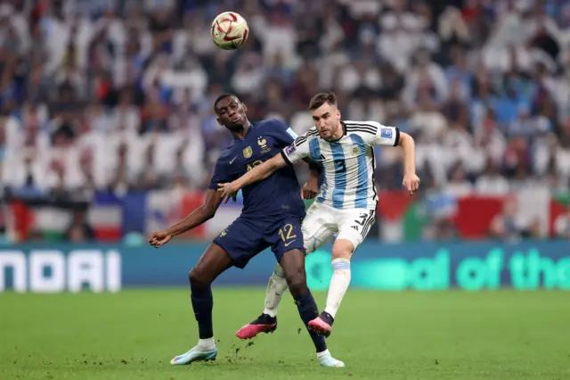 Randal Kolo Muani of France and Nicolas Tagliafico of Argentina compete for the ball during the FIFA World Cup Qatar 2022 Final match between Argentina and France at Lusail Stadium