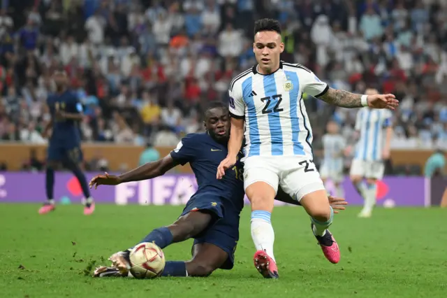 Dayot Upamecano of France battles for possession with Lautaro Martinez of Argentina during the FIFA World Cup Qatar 2022 Final match between Argentina and France at Lusail Stadium