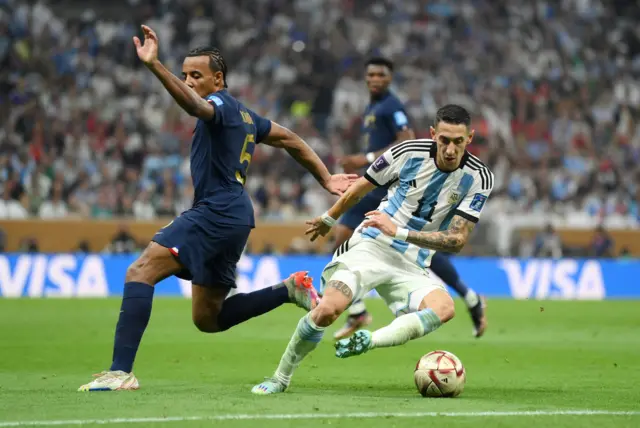 Jules Kounde of France battles for possession with Angel Di Maria of Argentina during the FIFA World Cup Qatar 2022 Final match between Argentina and France at Lusail Stadium