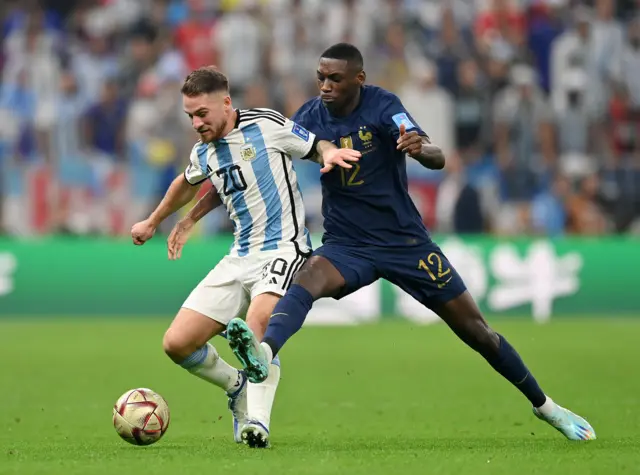 Alexis Mac Allister of Argentina battles for possession with Randal Kolo Muani of France during the FIFA World Cup Qatar 2022 Final match between Argentina and France at Lusail Stadium