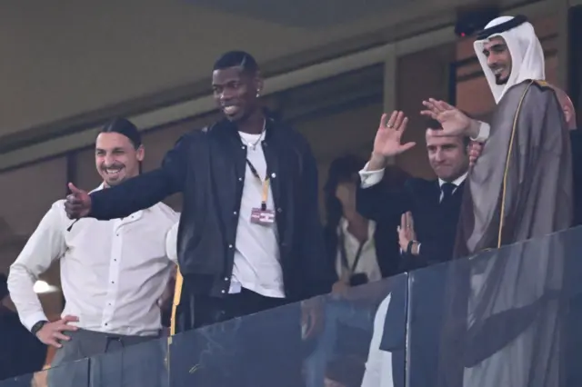 French football player Paul Pogba (2ndL) gives a thumbs-up as he attends with Swedish football player Zlatan Ibrahimovic (L) and French President Emmanuel Macron (2ndR) the Qatar 2022 World Cup final football match between Argentina and France at Lusail Stadium in Lusail, north of Doha on December 18, 2022