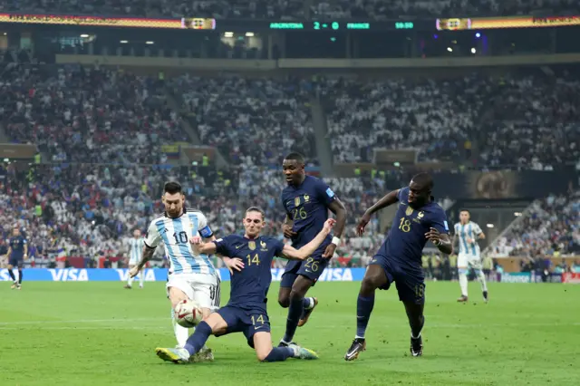 Lionel Messi of Argentina battles for possession with Adrien Rabiot, Dayot Upamecano and Marcus Thuram of France during the FIFA World Cup Qatar 2022 Final match between Argentina and France at Lusail Stadium