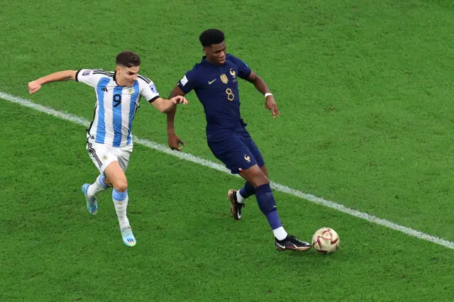 Aurelien Tchouameni of France controls the ball against Julian Alvarez of Argentina during the FIFA World Cup Qatar 2022 Final match between Argentina and France at Lusail Stadium