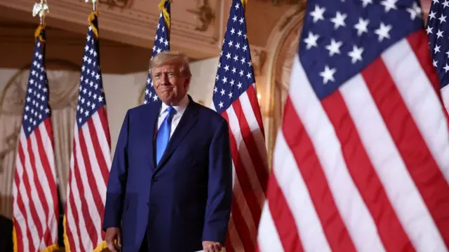 Donald Trump stands in front of American flags during an election night event at Mar-a-Lago in November