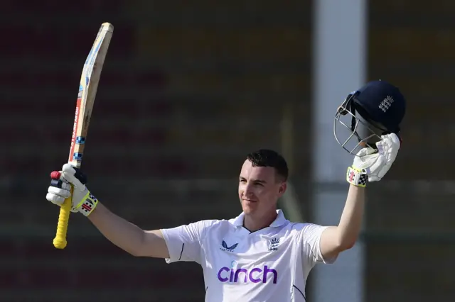 Harry Brook raising his bat after scoring a century