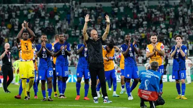 USA team celebrate qualification to the last 16 of the World Cup, after beating Iran.