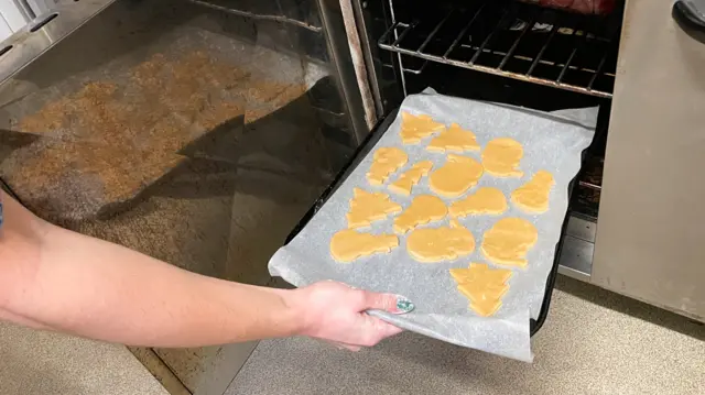 Feast First volunteers preparing gingerbread biscuits for residents at a shelter in north London