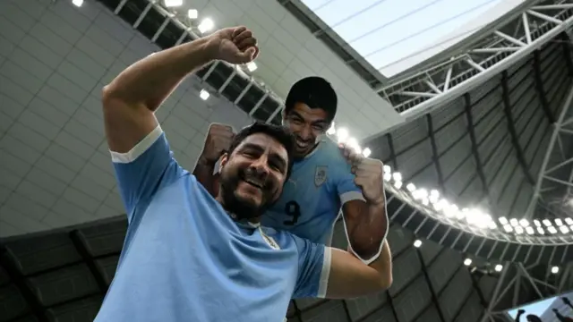 A Uruguay fan with a Luis Suarez cut-out