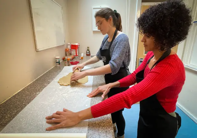 Feast First volunteers preparing gingerbread biscuits for residents at a shelter in north London