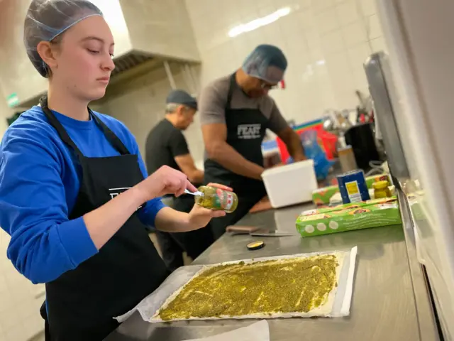 Feast First volunteers preparing lunch for residents at a shelter in north London