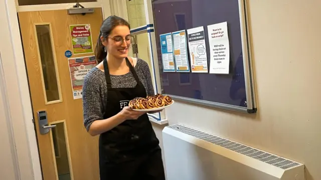 Ellie brings out some of the snacks for the festive lunch