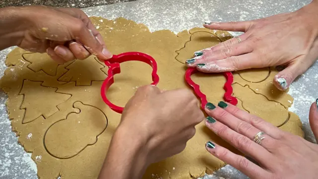 Feast First volunteers preparing gingerbread biscuits for residents at a shelter in north London