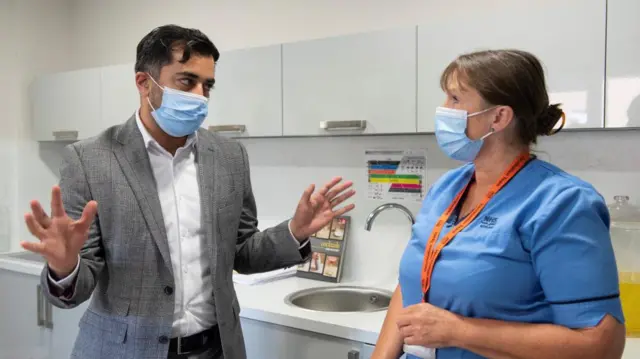 Scottish Health Secretary Humza Yousaf meets nurse Laura Hastings during a care home visit