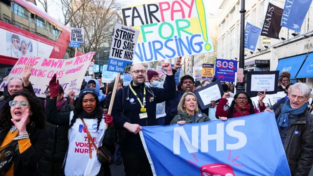 NHS nurses hold signs during a strike