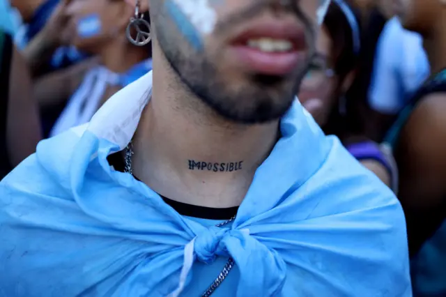 General view as a Argentina fan's tattoo reading impossible is seen ahead of the victory parade