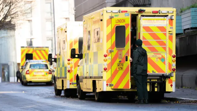 Picture of three ambulance vans and a car