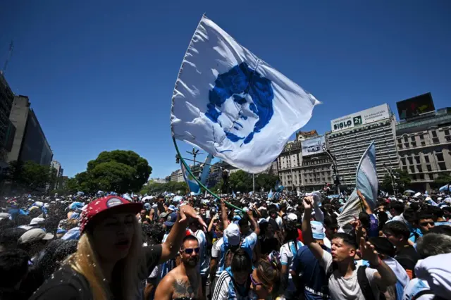 Fans of Argentina wait for the bus with Argentina's players to pass through