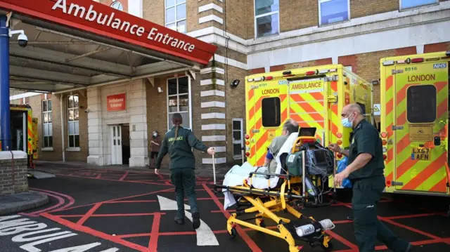 NHS ambulance staff outside a hospital in London today