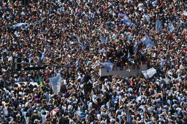 Fans of Argentina wait for the bus with Argentina's players to pass through