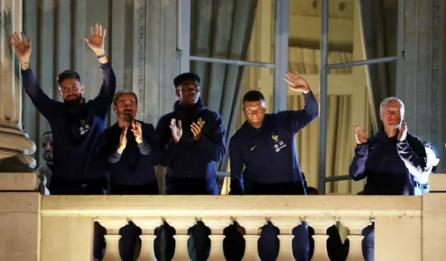 Olivier Giroud, Antoine Griezmann, Aurelien Tchouameni, Kylian Mbappe and head coach Didier Deschamps of Team France react with fans