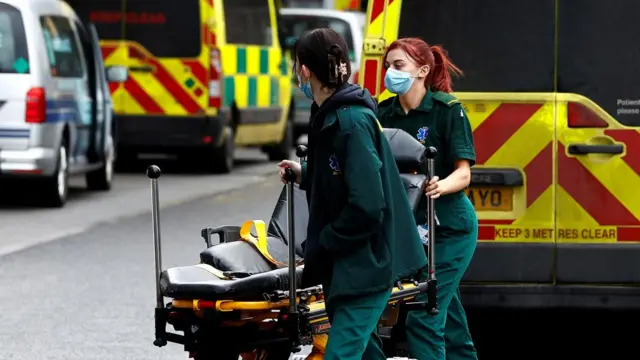 Two paramedics in front of an ambulance