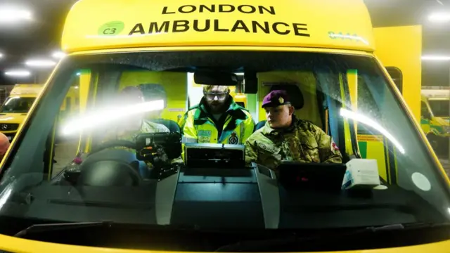 Military personnel inside an ambulance