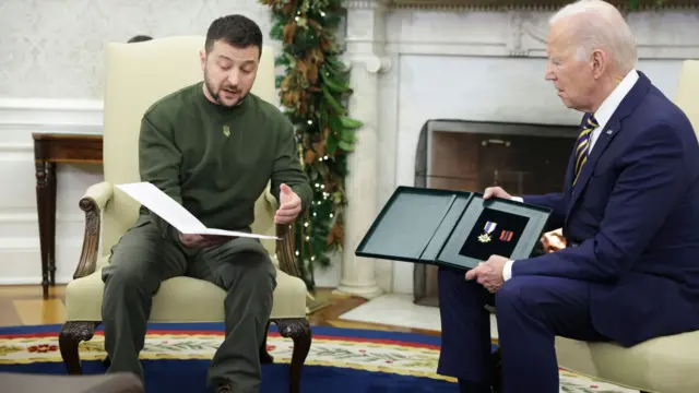 Zelensky gives Biden a military medal during meeting