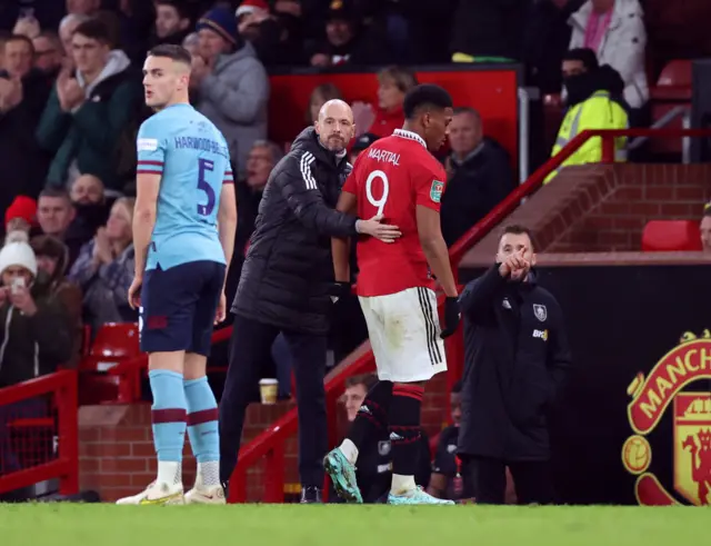 Erik ten Hag pats Anthony Martial on the back