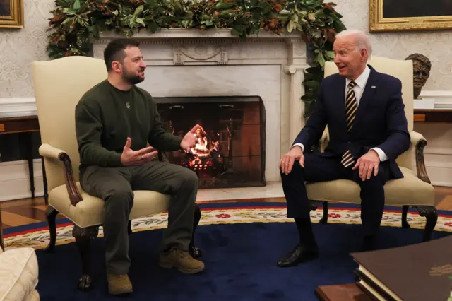 Presidents Zelensky and Biden sit and talk