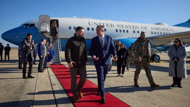 Zelensky is pictured meeting a US official after disembarking from his flight