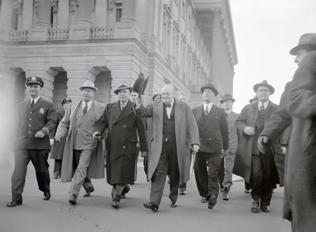 Prime Minister Winston Churchill of Great Britain is surrounded by United States and British Secret Service men, as he arrives at the Capitol to deliver an address before the joint session of Congress.