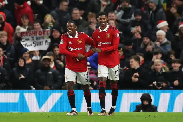 Marcus Rashford of Manchester United celebrates scoring their side's second goal with teammate Tyrell Malacia during the Carabao Cup Fourth Round match between Manchester United and Burnley at Old Trafford