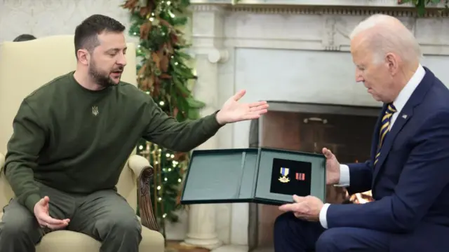 President Zelensky of Ukraine gives President Biden of America a military award