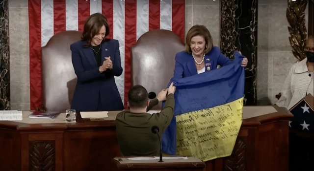 Zelensky holds up the flag