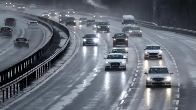 Traffic creates spray as it drives through rain on the M1 Motorway in Bedfordshire, Britain