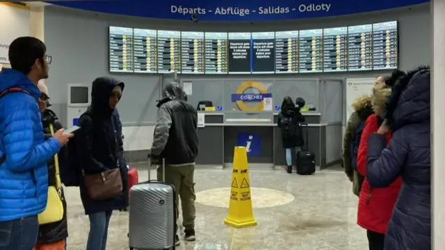 People wait at Victoria coach station