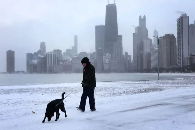 A man walks his dog near downtown Chicago on Thursday, as sub-zero temperatures grip the city.