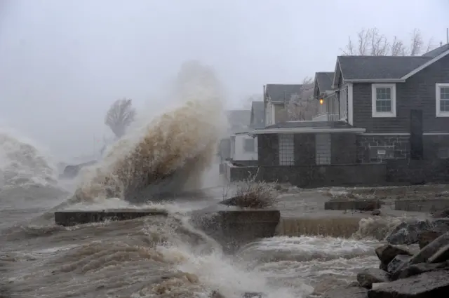 Waters from Lake Erie wash over the shoreline outside Buffalo, in up-state New York. As well as snow and ice, residents of eastern America are also having to deal with concerns about flooding.