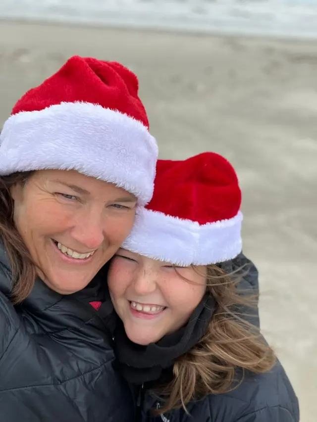 Annick and Émeline Ruedi donned Santa hats for their (very) brief excursion to Mustang Island's beach on Friday.