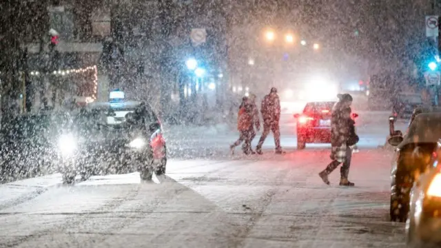 Snow falls on a street in Montreal, Quebec on Thursday